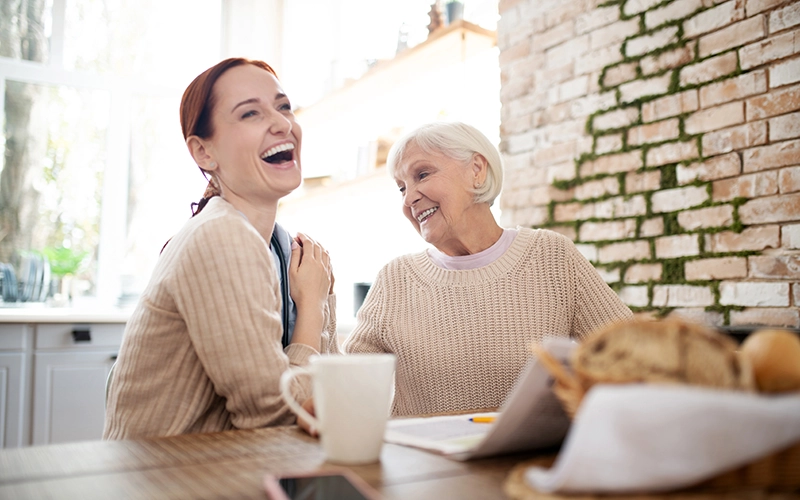 smiling woman with elderly woman